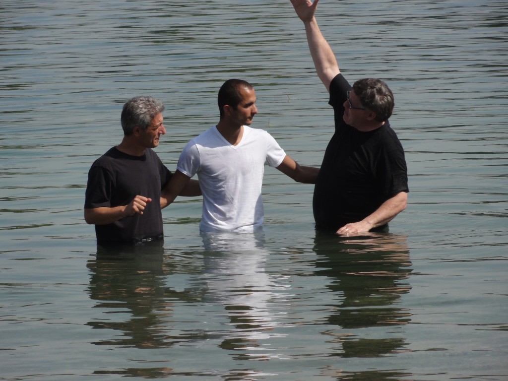 Arish (former refugee who was persecuted in his homeland) and Mihal (pastor of Zagreb church) perform baptism for a refugee.