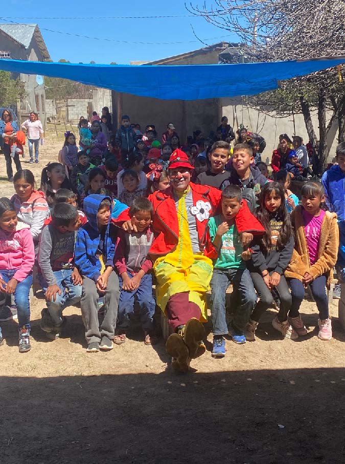 Juan in full clown attire to share the gospel with children in rural areas.