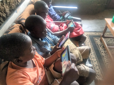 Home school in Kenya where the children are happily using the Knowledge Box to support learning.