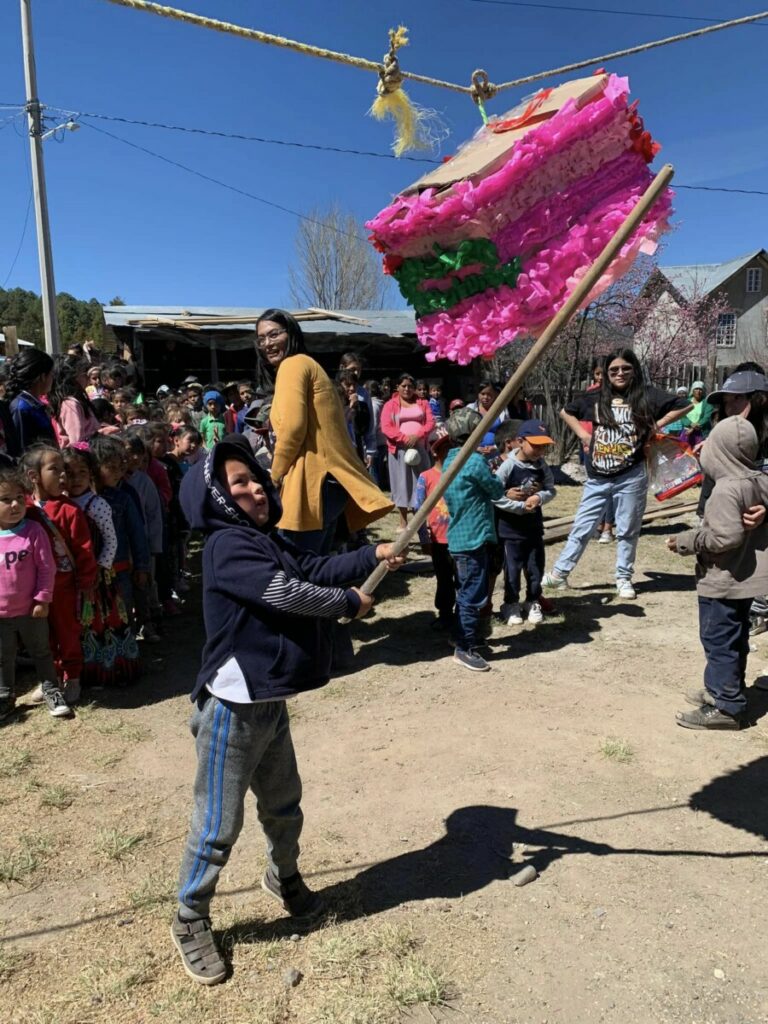 Children taking turns with the piñata.