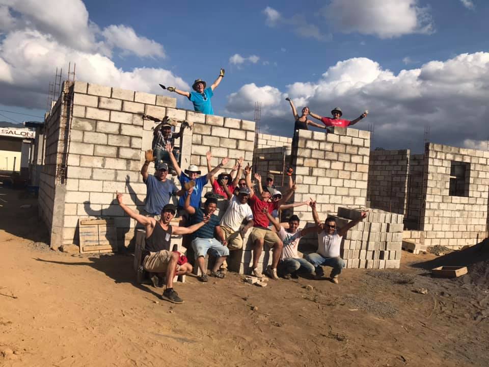 Team in front of new block construction.