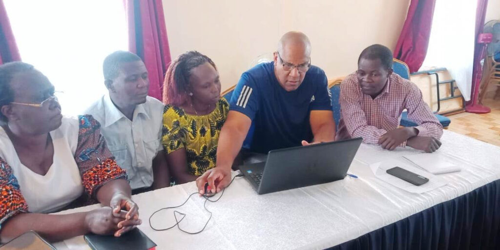 Rev. Prof. Collin Miller, second right, showing a group of pastors the basics of Microsoft Word during the leadership training.