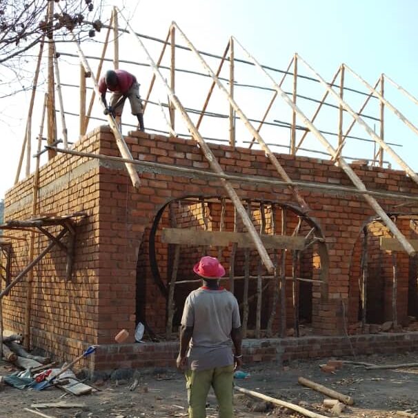 Roofing going up on the bathhouse.